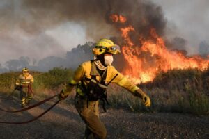 As Europe prepares for an energy crisis, firefighters try to extinguish a wildfire in northern Spain during a July heatwave.