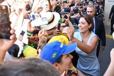 former first lady of Brazil greets supporters the day her husband returned to Brazil after a short self exile in the US.