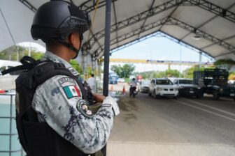 A Mexican National Guard member monitors a checkpoint in Chiapas, Mexico, in June 2023.