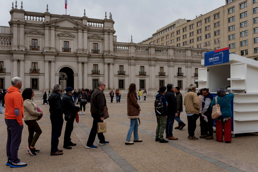 People in Santiago, Chile line up to get a free copy of a proposed new constitution.