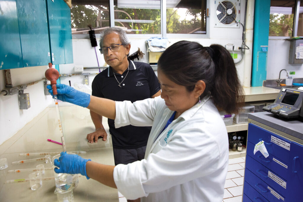 Dr. Jorge Herrera Silveira, left, a researcher, and Eunice Pech, a laboratory assistant, prepare a mangrove chemical monitoring report at the Center for Research and Advanced Studies at the National Polytechnic Institute in Mérida in November. Herrera advises the Chelemeras’ restoration project, which he helped to found.