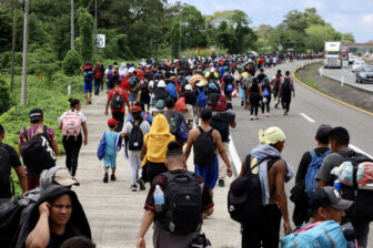 Migrants walk in a caravan in Huixtla, Mexico en route to the U.S. on Nov. 21