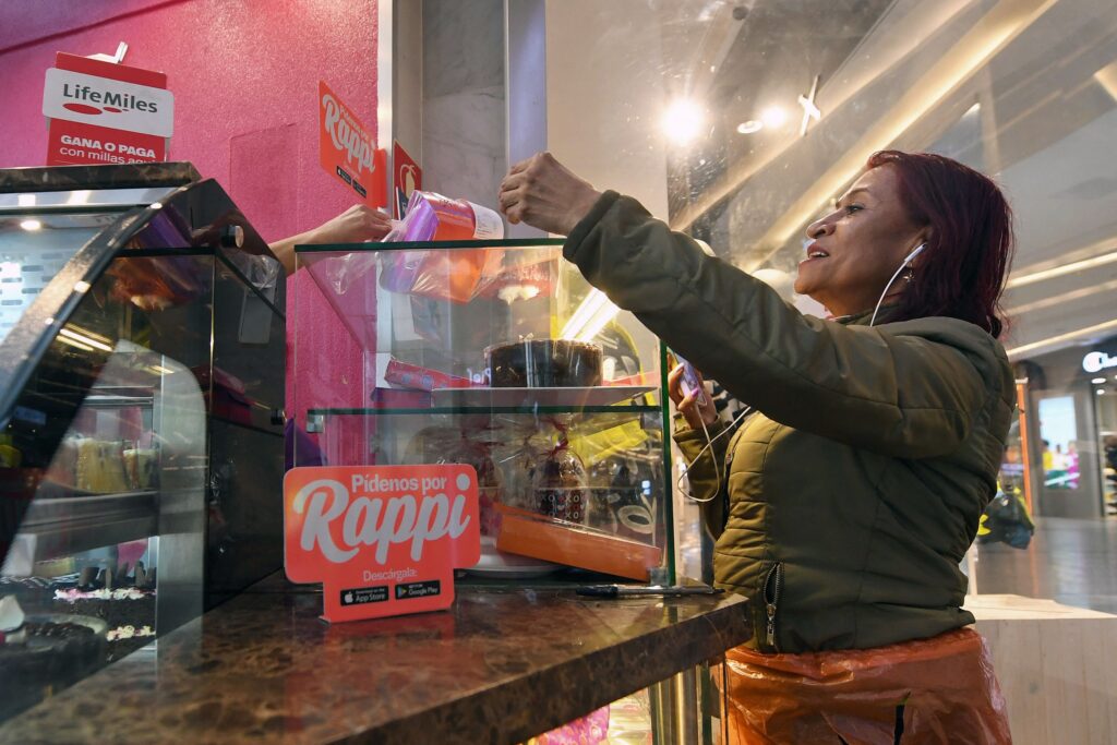 Luz Miryam Fique, a motorcycle courier and president of Colombia’s Digital Platform Workers Union (Unidapp), picks up an order at a restaurant in Bogotá.