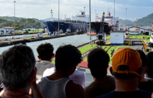 People look at two cargo ships entering the Miraflores Locks of the Panama Canal on January 22.