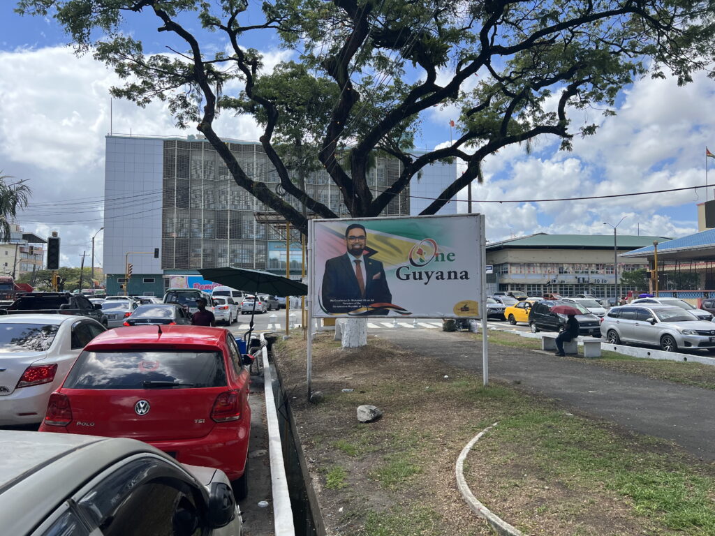 Guyana’s Promise Is Still a Work in Progress. View of one of Georgetown's main avenues. A billboard features President Irfaan Ali in November 2023.