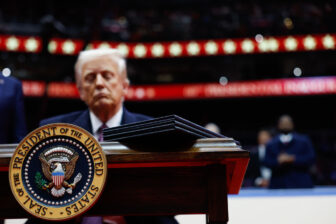 WASHINGTON, DC - JANUARY 20: U.S. President Donald Trump signs executive orders during an indoor inauguration parade at Capital One Arena on January 20, 2025 in Washington, DC. Donald Trump takes office for his second term as the 47th president of the United States.