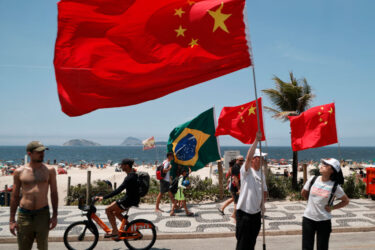 Bystanders await President Xi Jinping during the G20 Meeting in Rio de Janeiro in Nov 2024.