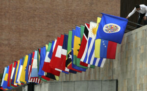 A worker prepares the flags of the Organization of American States (OAS) outside a press conference on May 30, 2008 in Medellin. The 38th regular session of the OAS General Assembly will be held from June 1 to 3 in Medellin, Colombia.