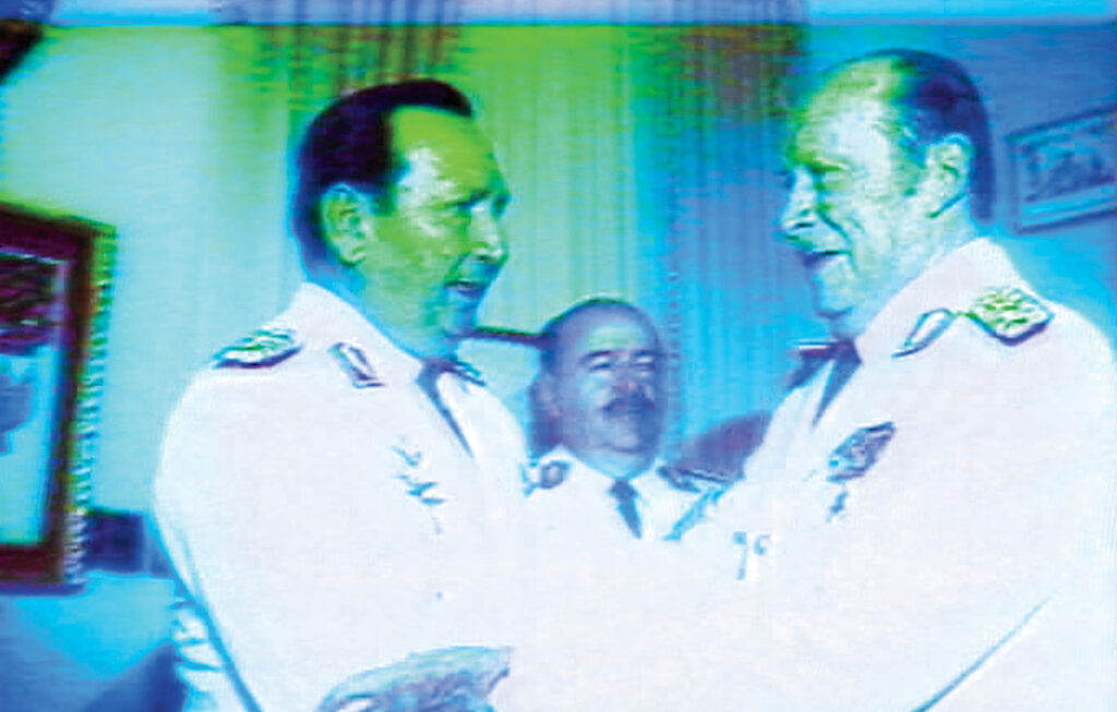 In this still from Under the Flags, the Sun, Paraguayan dictator Alfredo Stroessner (right) speaks with Andrés Rodríguez Pedotti, who later overthrew Stroessner in a coup in 1989.
