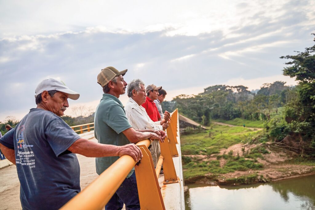 Residents of the small town of José María Morelos, Oaxaca, stand on a new bridge built as part of the CIIT. The town is not along any rail route, but the bridge is part of the broader effort to improve infrastructure in the region that the CIIT traverses. “Before the construction of the Interoceanic Corridor, we were isolated during the rainy season," said Fernando Ponce Torres, a town council member in José María Morelos. "Our suspension bridge was swept away by floods last year. The CIIT funded a new concrete bridge, and thanks to that, our village is accessible by car even during the rainy season.”