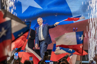 President-elect José Antonio Kast waves a Chilean flag during an election night rally in Santiago on Dec. 14, 2025.