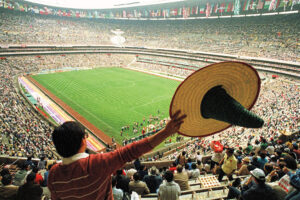 A Mexican fan waves a sombrero at the Estadio Azteca in Mexico City ahead of the 1986 World Cup opening ceremony.