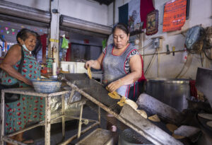 A woman runs a tortillería in Mérida, Mexico, in 2024.