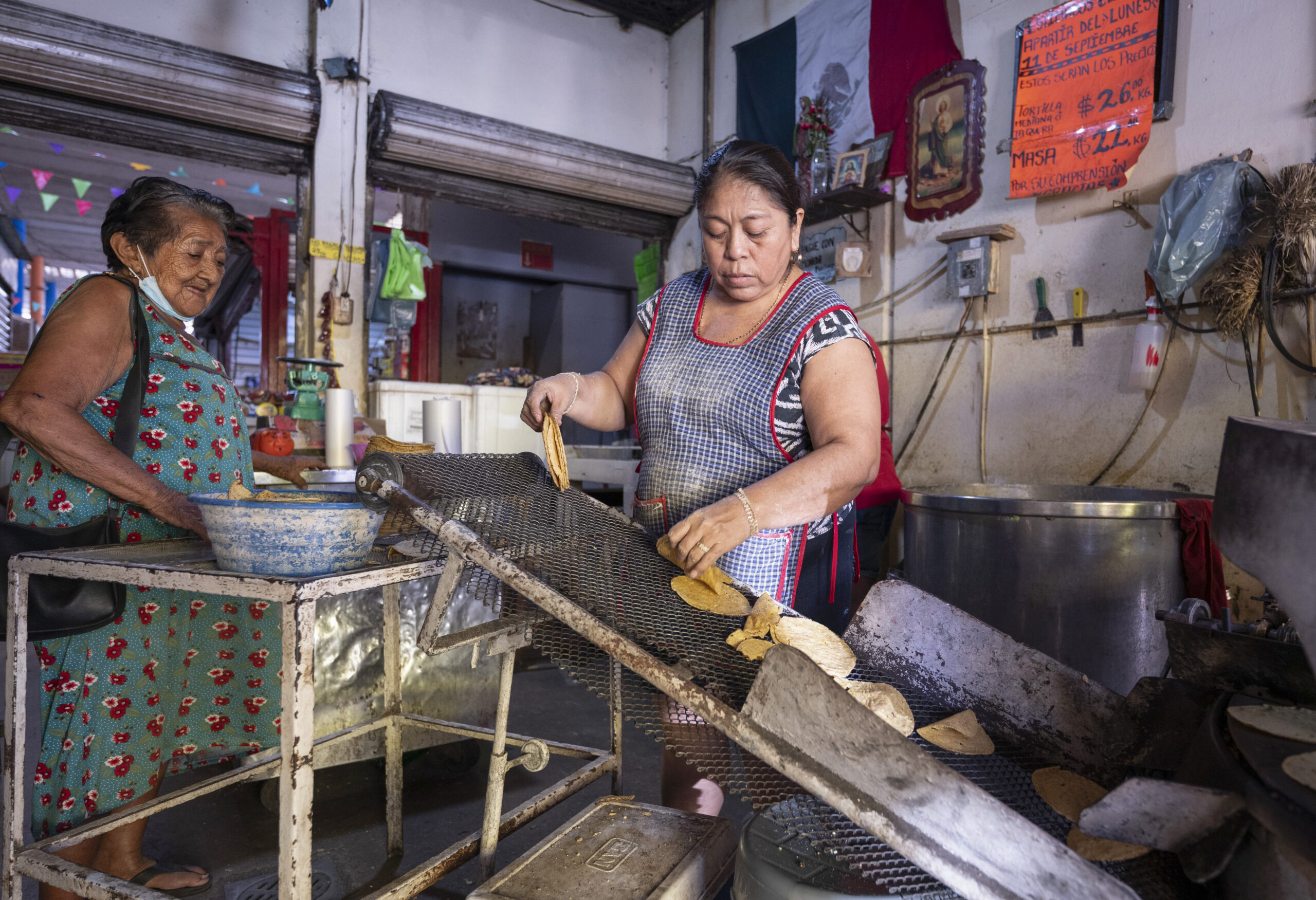 A woman runs a tortillería in Mérida, Mexico, in 2024.