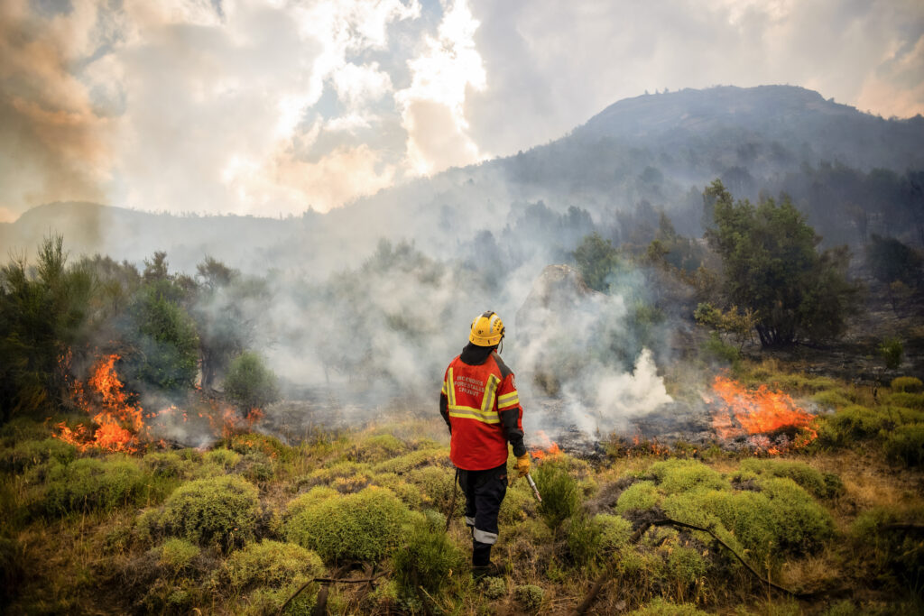 A firefighter works to extinguish a forest fire in Argentina’s Chubut province in February.