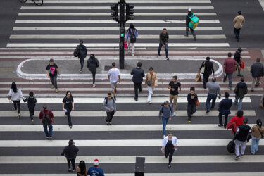 Commuters cross Avenida Paulista in the financial district of São Paulo, Brazil, in May.